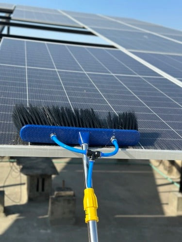 Solar panel cleaning brush with water-fed pole